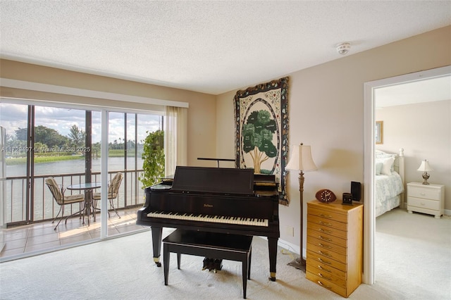 9400 N Hollybrook Lake Dr Unit 303, Pembroke Pines, FL 33025 - sitting room featuring carpet flooring, a textured ceiling, and a water view