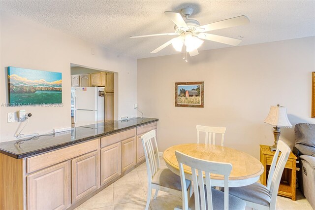 kitchen with white appliances, electric panel, a textured ceiling, and light tile patterned flooring