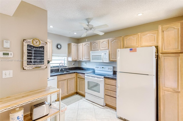 kitchen with sink, white appliances, a textured ceiling, and light brown cabinetry