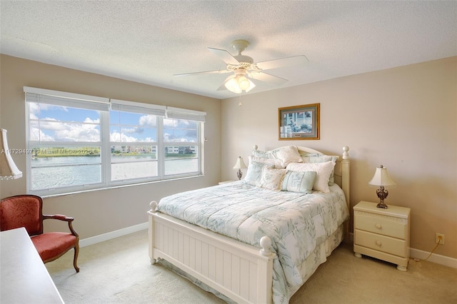 9400 N Hollybrook Lake Dr Unit 303, Pembroke Pines, FL 33025 - bedroom featuring baseboards, a textured ceiling, light colored carpet, and ceiling fan