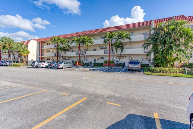 9400 N Hollybrook Lake Dr Unit 303, Pembroke Pines, FL 33025 - view of building exterior featuring uncovered parking and a residential view