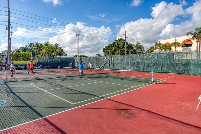 view of tennis court featuring basketball hoop