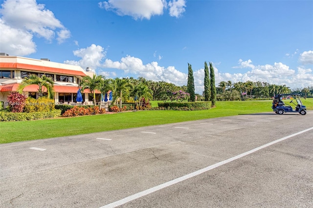 view of vehicle parking featuring a lawn