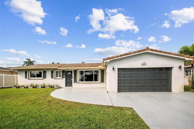 ranch-style house featuring a front yard and a garage