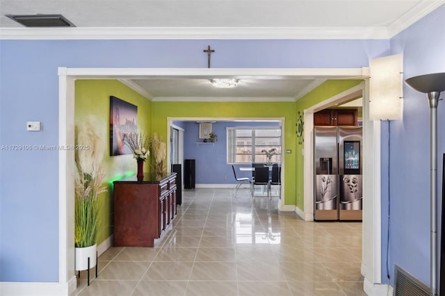 hall with crown molding and light tile patterned floors