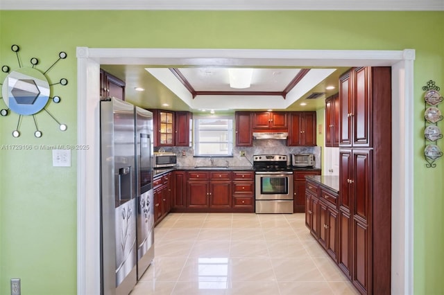 kitchen with stainless steel appliances, sink, backsplash, ornamental molding, and a raised ceiling