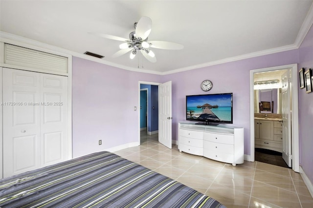 unfurnished bedroom featuring crown molding, ceiling fan, light tile patterned floors, connected bathroom, and a closet