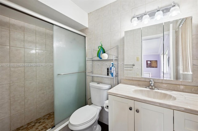 bathroom featuring a shower with shower door, tile walls, and toilet