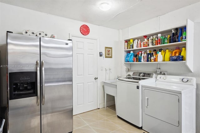 washroom featuring separate washer and dryer and light tile patterned flooring