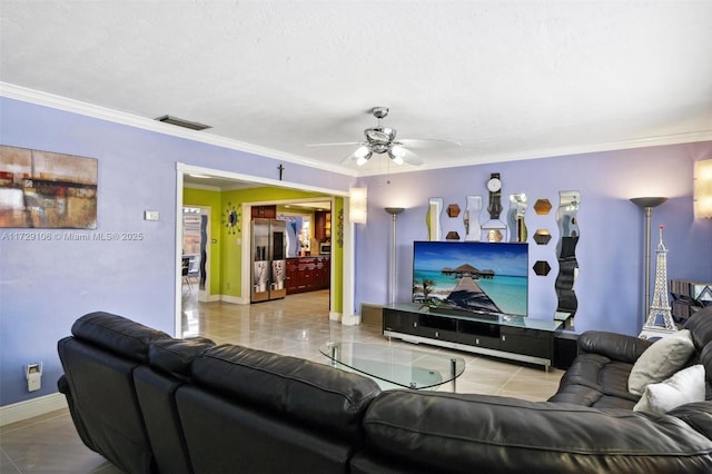 living room featuring ceiling fan, crown molding, and light tile patterned floors