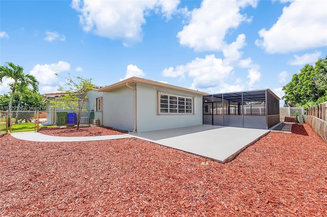 2070 NW 84th Ter, Pembroke Pines, FL 33024 - back of property featuring stucco siding, a fenced backyard, a patio, and glass enclosure