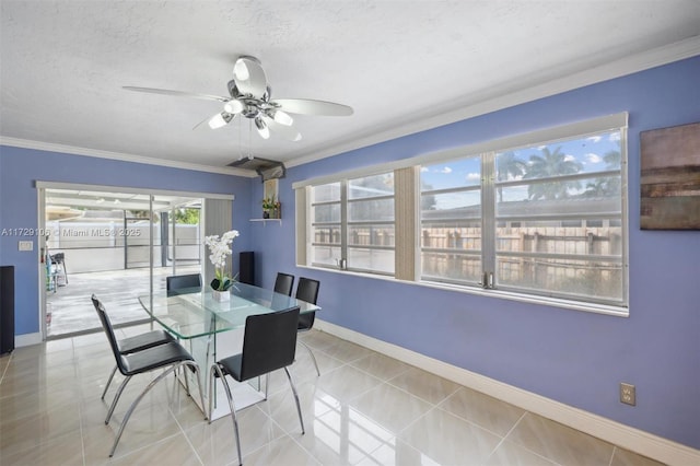 tiled dining area featuring ceiling fan, a textured ceiling, and crown molding