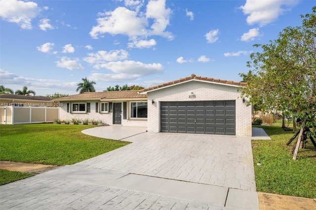 single story home with a front yard and a garage