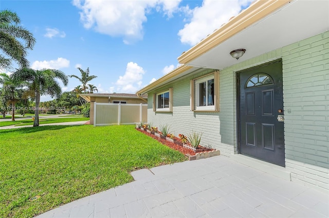 2070 NW 84th Ter, Pembroke Pines, FL 33024 - property entrance featuring a yard, brick siding, and a patio area