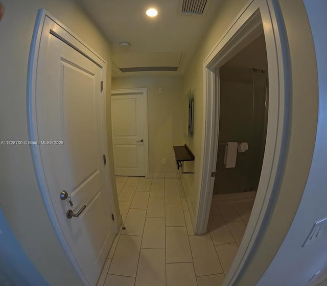 hallway featuring light tile patterned floors