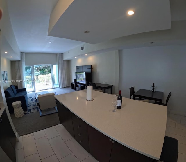 kitchen featuring a kitchen island and light tile patterned floors