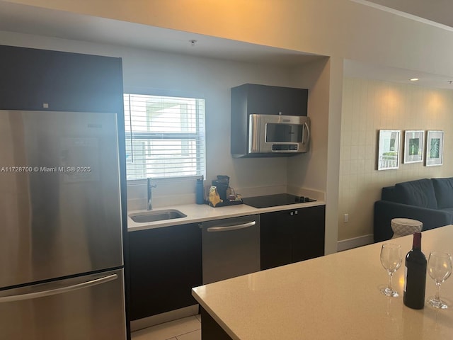 kitchen with sink, light tile patterned floors, and stainless steel appliances