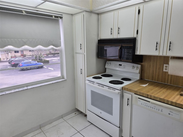 kitchen featuring white cabinetry, white appliances, and light tile patterned flooring