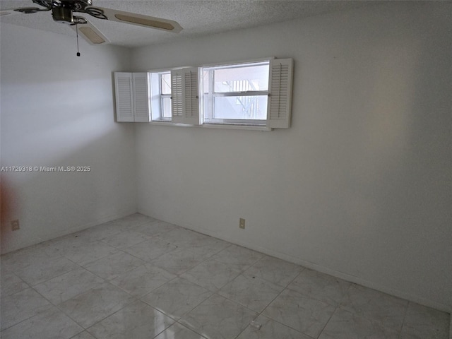 spare room with ceiling fan and a textured ceiling