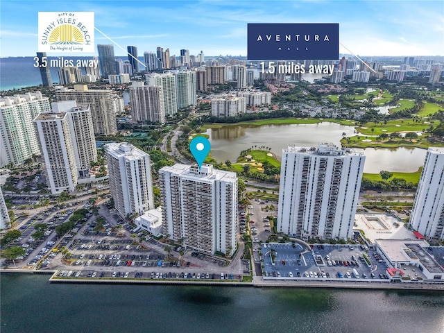 drone / aerial view featuring a water view and a view of city