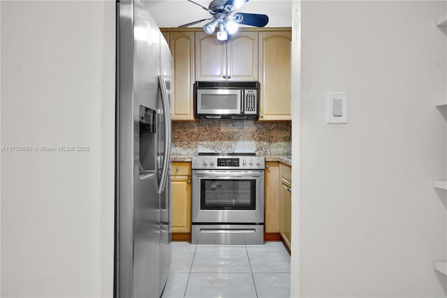 kitchen featuring a ceiling fan, appliances with stainless steel finishes, tasteful backsplash, and light tile patterned flooring