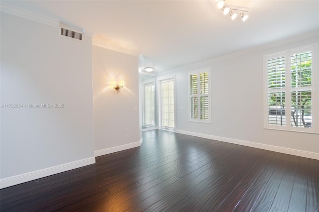 empty room with dark wood-type flooring and crown molding