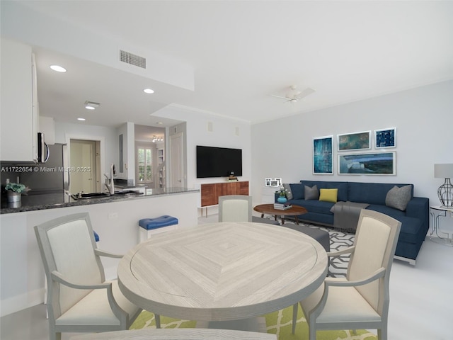 dining room with ceiling fan and sink