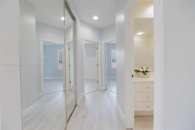 hallway with light hardwood / wood-style floors