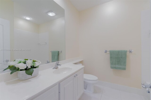 bathroom featuring tile patterned floors, vanity, toilet, and walk in shower