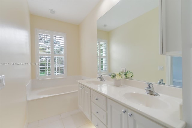 bathroom featuring vanity, a washtub, and tile patterned floors