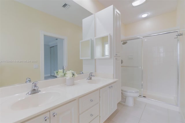 bathroom featuring a shower with door, toilet, tile patterned floors, and vanity