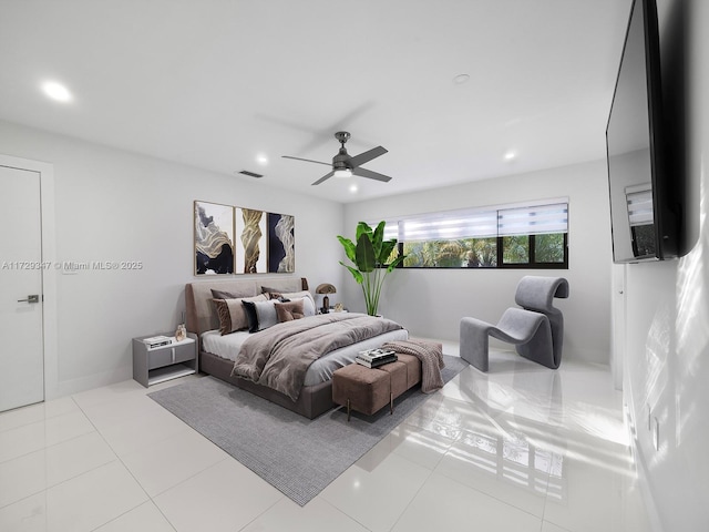 tiled bedroom featuring ceiling fan