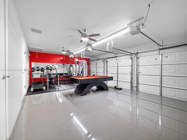 garage featuring a garage door opener and ceiling fan