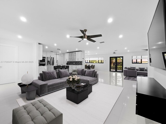 living room featuring ceiling fan, light tile patterned floors, and french doors