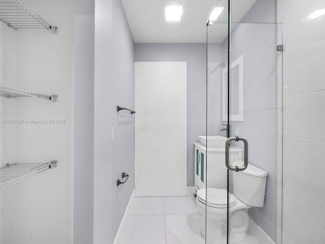 bathroom with sink, toilet, and tile patterned floors