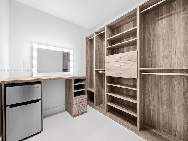 spacious closet featuring light tile patterned floors