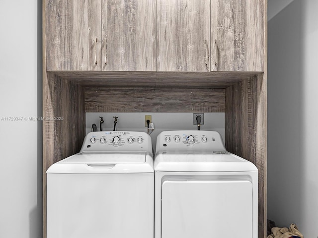 clothes washing area featuring cabinets and independent washer and dryer