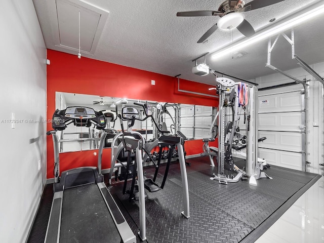 exercise room with ceiling fan and a textured ceiling