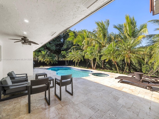 view of swimming pool featuring an in ground hot tub, a patio, and ceiling fan