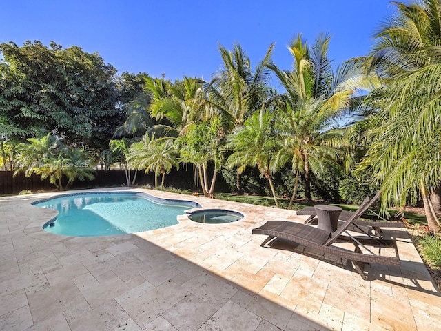 view of pool featuring an in ground hot tub and a patio