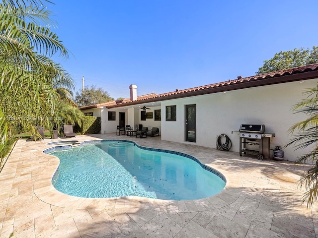 view of pool with an in ground hot tub, a patio, ceiling fan, and a grill