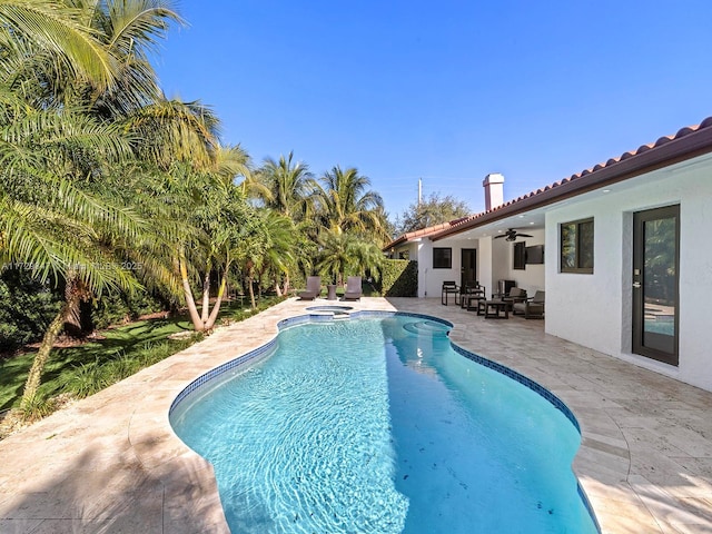 view of pool with ceiling fan and a patio