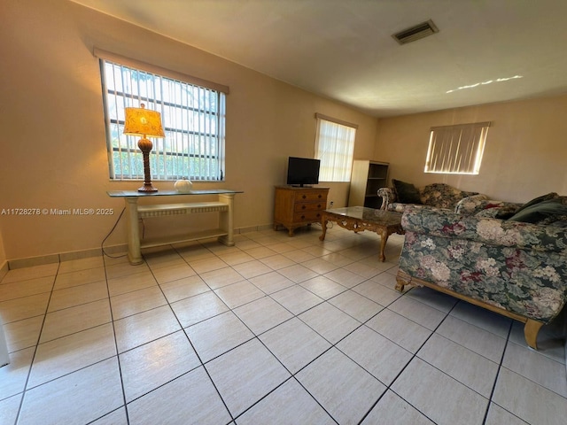 living room featuring light tile patterned flooring and a healthy amount of sunlight