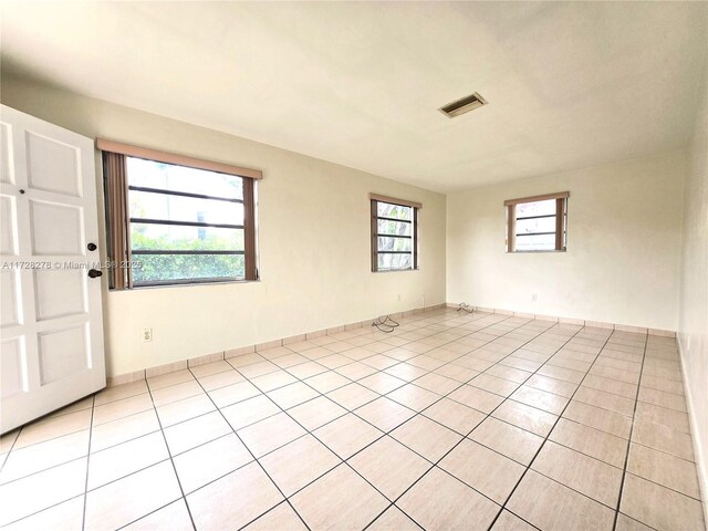 7200 NW 4th St, Miami, FL 33126 - empty room with light tile patterned floors and baseboards
