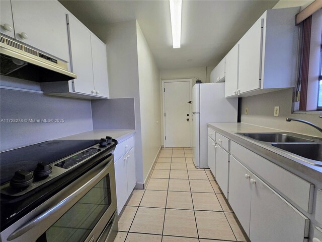7200 NW 4th St, Miami, FL 33126 - kitchen featuring electric stove, a sink, under cabinet range hood, light tile patterned flooring, and light countertops