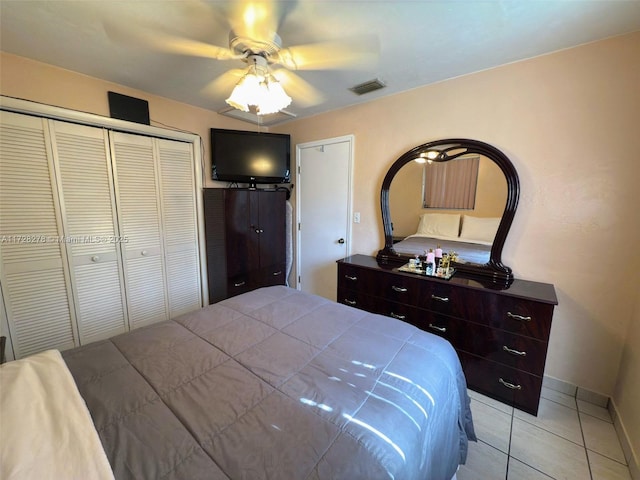 bedroom with a closet, ceiling fan, and light tile patterned floors