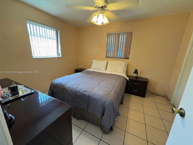 tiled bedroom with ceiling fan