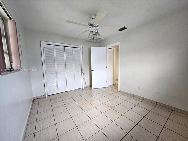 7200 NW 4th St, Miami, FL 33126 - unfurnished bedroom with light tile patterned floors, a closet, and baseboards