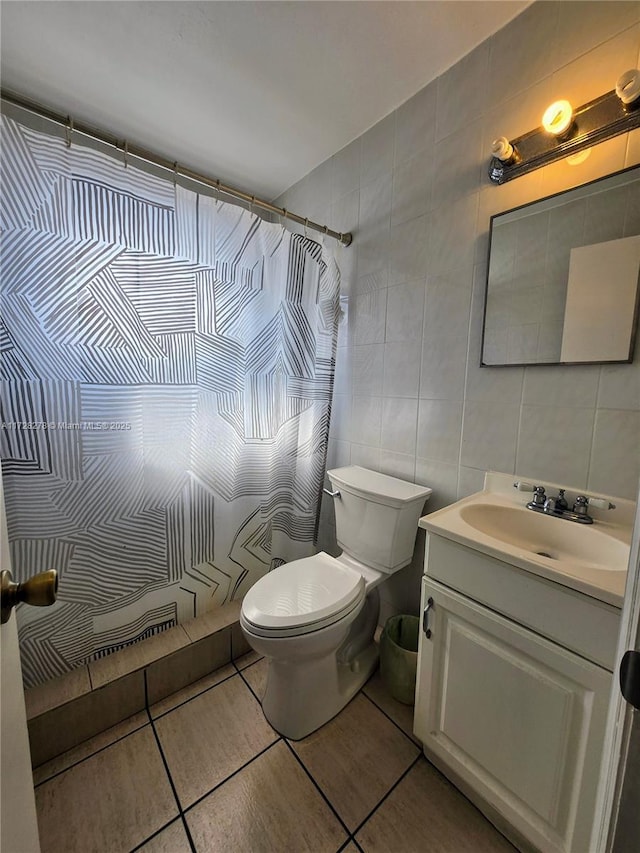 bathroom featuring tile patterned flooring, tile walls, curtained shower, toilet, and vanity