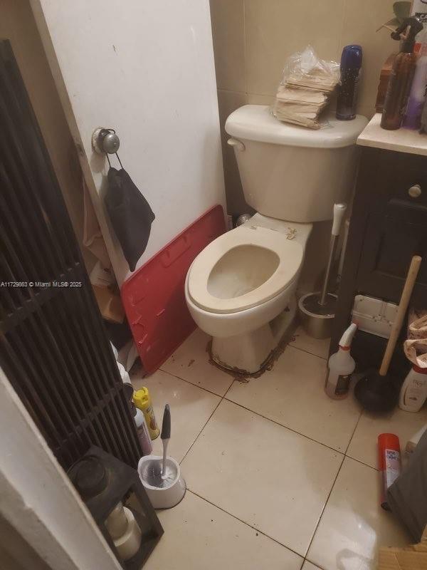 bathroom with toilet and tile patterned flooring